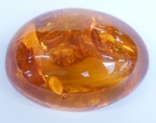 An amber cabochon, 53.7x37.6x20.2mm, 24g.