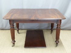 Victorian mahogany extending dining table with extra leaf, reeded legs and brass castors, max