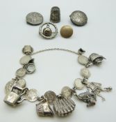 A silver Maundy bracelet set with silver charms, Victorian silver buttons, silver thimble etc