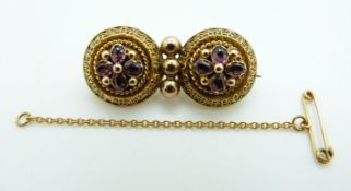 Victorian Etruscan Revival gold brooch set with foiled amethysts within applied rope twist