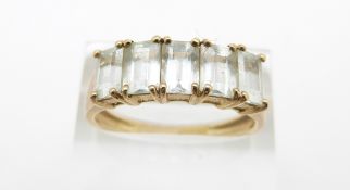 A 9ct gold ring set with rectangular cut aquamarines, 3.4g, size V