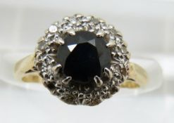 An 18ct gold ring set with a sapphire surrounded by diamonds, 3.3g, size I