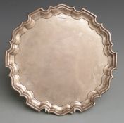 Walker and Hall George VI hallmarked silver salver with shaped edge raised on three scroll feet,