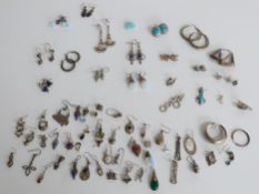 A large collection of silver earrings including Mackintosh style examples, gem set examples etc