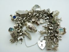 A silver charm bracelet with 42 charms including a Maori tiki, koala, platypus, lamb, cuckoo