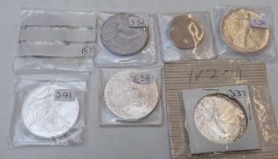 Five USA silver one dollar coins together with a one dollar and half dollar cupro nickel examples