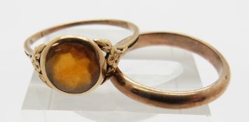 A 9ct gold ring set with a citrine and a yellow metal wedding band marked 333, 4.9g