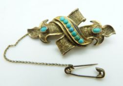 Victorian gold brooch with engraved decoration,set with turquoise cabochons, 5.3g, 4.7 x 2.1cm