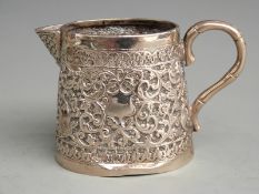 Indian or similar white metal jug with embossed decoration, height 7cm weight 106g