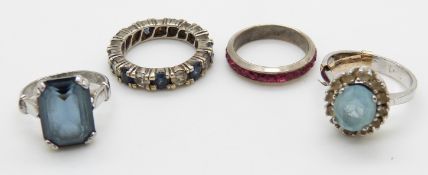 A silver eternity ring set with blue and clear sapphires, two silver rings,14.4g, and another ring