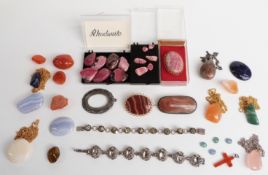 A collection of polished agate jewellery and samples.