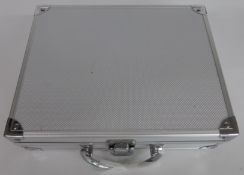 Amateur collection of various coins in a metal collector's case