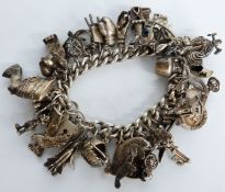 Silver charm bracelet including weather vane, space shuttle, cat, rocking horse and other charms