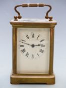 20thC French brass carriage clock with Roman enamelled dial, blued steel hands and corniche style