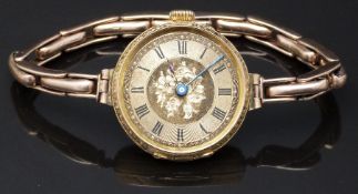 18ct gold ladies wristwatch with blued hands, black Roman numerals, engraved self coloured dial,