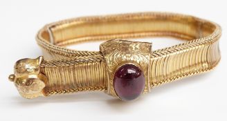 An early Victorian bracelet set with a foiled garnet cabochon to the engraved foliate clasp, 20.7g