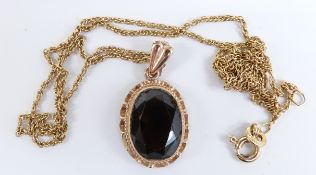 A 9ct gold pendant set with smoky quartz and a chain, 4.3g