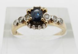 A 9ct gold ring set with a sapphire and diamonds, 2.3g, size O