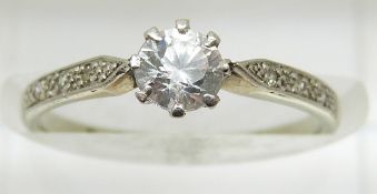 An 18ct white gold ring set with a cubic zirconia and diamonds to the shoulders, 1.7g, size L
