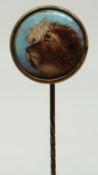 A stick pin with enamel dog finial