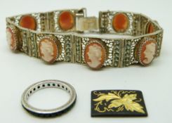 An 800 grade silver filigree bracelet set with cameos and a silver ring
