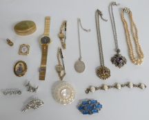 A collection of costume jewellery including a Scottish style silver pendant, brooches, mother of