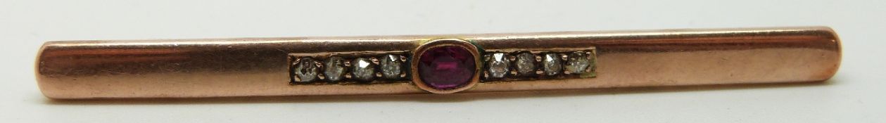 A 14ct gold brooch set with an oval cut ruby and old cut diamonds