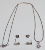 An 18ct white gold necklace set with a pear cut diamond of approximately 0.45ct and a round cut