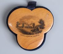 Mauchlinware pin cushion of trefoil form depicting Chillingham Castle and marked 'made of wood grown