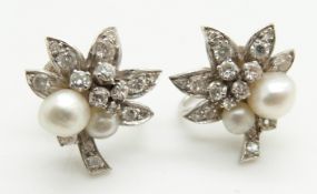 A pair of early 20thC white metal earrings set with two pearls and diamonds to each in the form of a
