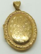 A 9ct gold locket with engraved decoration, 13.4g
