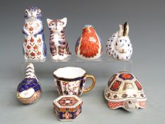 A group of Royal Crown Derby ceramics to include Imari paperweights, cup and trinket dish