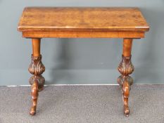 19th century burr walnut fold over games table raised on carved legs with octagonal columns, size