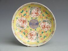 A 19thC Chinese famille jaune plate with four circular panels depicting dragons and six character