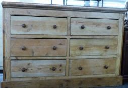 A 19th/20thC pine chest of six straight drawers with turned knobs, raised on a straight plank