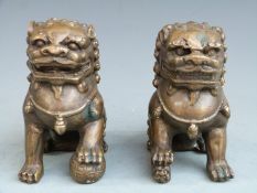 A pair of brass/ bronze Chinese Dogs of Fo, 10.5cm tall