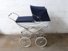 Silver Cross coach built pram with sprung suspension and navy hood/ cover, height to handle 96cm