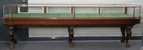 Victorian oval glazed museum / shopfitting cabinet, the four fall flap doors with looped brass