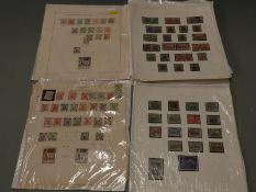 A selection of early European stamps on loose album sheets, including Danzig, Latvia, Saar and