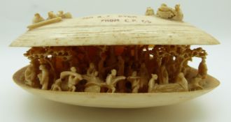 19thC Chinese carved ivory oyster shell, the interior containing many figures, trees, cart and