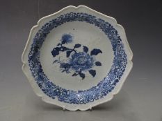 19thC Chinese shallow dish/charger with gadrooned rim decorated with a peony and floral border, H4.