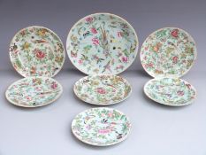 Seven Chinese Canton famille rose plates each decorated with birds, butterflies and flowers, largest