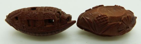 19thC Chinese peach stone carved as a junk with script to the base, together with another peach