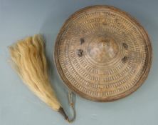 North African tribal leather shield and fly swat, the shield 33cm in diameter