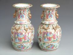 A pair of 19thC Chinese Canton famille rose vases of baluster form decorated with figural court
