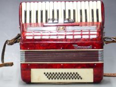 Parrot 48 bass piano accordion with five treble couplers, in red pearloid finish