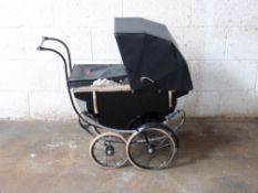 A vintage anonymous coach built dolls pram with sprung suspension, mudguards to front wheels,