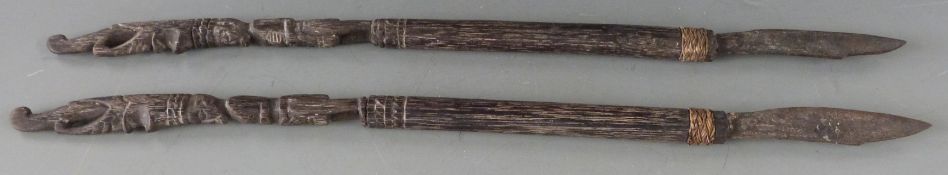 Pair of African carved hardwood slashing or skinning knives with branded wire work decoration, L55cm