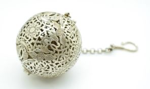 A pierced incense burner with bird decoration and suspension chain, the interior with gyroscope