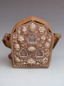 Tibetan white metal travelling shrine or reliquary with windows showing deities, in silk carrying